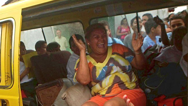 A woman laughs inside a van in Panama, which along with Paraguay, has the happiest people in the world. (AP Photo/Arnulfo Franco)