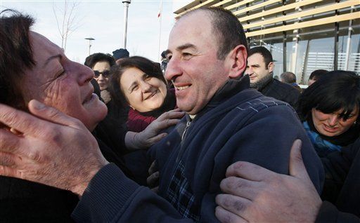 Relatives hug a former prisoner as he leaves Gldani prison No. 8 in Tbilisi, Georgia, Sunday, Jan. 13, 2013. Nearly 200 inmates considered political prisoners by Georgia's new parliament have walked free under an amnesty strongly opposed by President Mikhail Saakashvili. Many of those who walked free on Sunday were arrested during anti-Saakashvili protests in May 2011. Others had been convicted of trying to overthrow the government or of spying for Russia. (AP Photo)