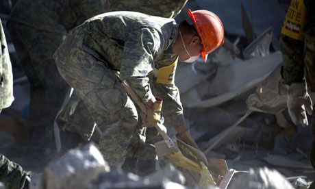 A soldier takes part in the rescue effort and clean-up at the shattered Pemex building in Mexico City. Source:AFP