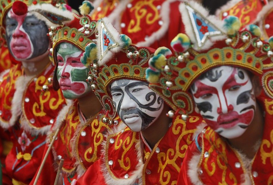 Traditional Chinese dancers wait to perform during the Chinese Lunar New Year Celebrations. The Lunar New Year, also known as the Spring Festival, begins on February 10 and marks the start of the Year of the Snake.  Photo:ibtimes.co.uk