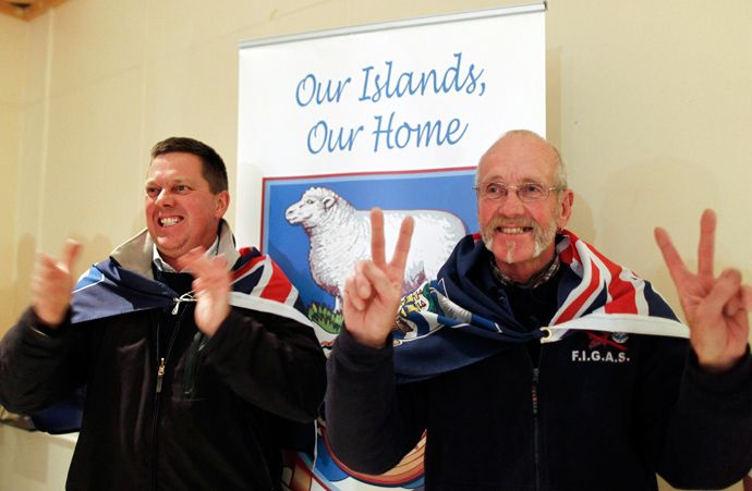 Falkland islanders react after hearing the results of the referendum at the vote counting station in the Town Hall in Stanley, March 11, 2013 (Reuters / Marcos Brindicci)