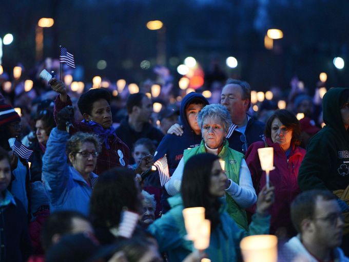 Hundreds gather in Garvey Park in Dorchester near the home of Martin Richard for a candlelight vigil in honor of the victims of the Boston Marathon bombings.  Credit: USA Today