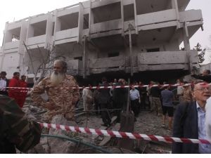 People stand among debris outside the French embassy after the building was attacked, in Tripoli - Source: Reuters