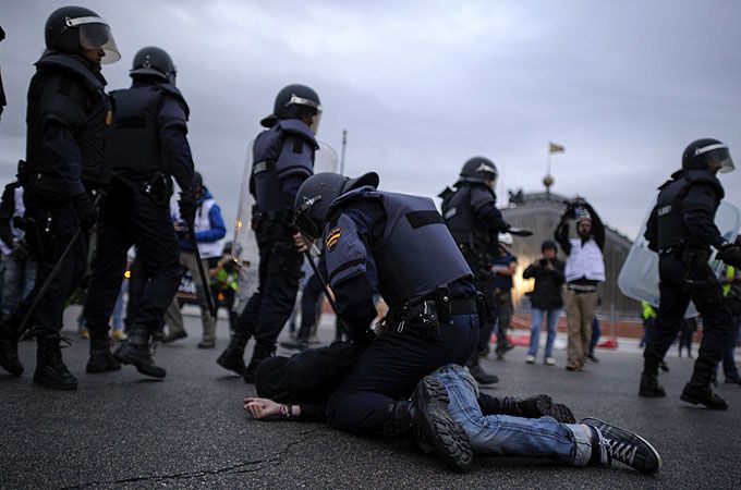 Police detained protesters in Madrid after hundreds gathered to call for the government to quit [AFP]