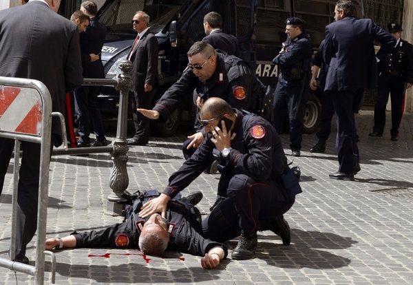 Police officers rushed to aid a fellow officer who was shot in the neck during an attack outside the Italian prime minister's office on Sunday.