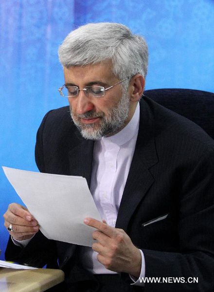 Iran's chief nuclear negotiator Saeed Jalili checks his documents as he registers his candidacy for Iran's 11th presidential election at the Interior Ministry in Tehran on May 11, 2013