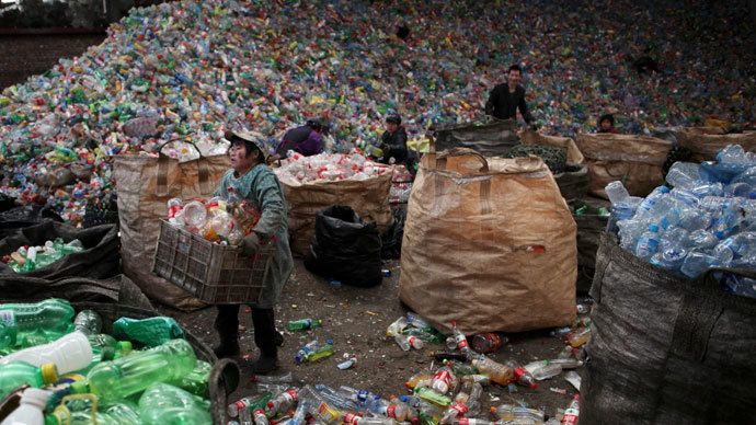 Workers sort waste plastic bottles at the Xiejiacun waste collection market in the Changping district of Beijing.(Reuters / China Daily)