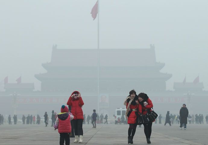 Visitors take pictures on Tiananmen Square during a foggy day in central Beijing, January 29, 2013. China issued a blue-coded alert on Sunday as foggy weather forecast for the coming two days will cut visibility and worsen air pollution in some central and eastern Chinese cities, Xinhua News Agency reported.(Reuters / China Daily)