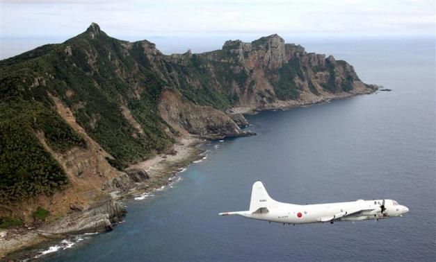 Japan Maritime Self-Defense Force's PC3 surveillance plane flies around the disputed islands in the East China Sea, known as the Senkaku isles in Japan and Diaoyu in China.@Reuters.