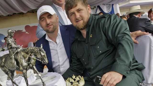 Russian Duma deputy Adam Delimkhanov (left, seen with Chechen leader Ramzan Kadyrov at an annual horse race in the Rostov-na-Donu) is one of the two deputies reportedly involved in the December 3 fight.