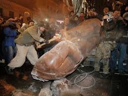 A Ukrainian protester slams a toppled monument of Vladimir Lenin in Kiev, Ukraine, on Sunday, December 8. Ukrainians occupied the square to denounce President Viktor Yanukovich's decision to turn away from Europe and align this ex-Soviet republic with Russia, as protests continued for a third week