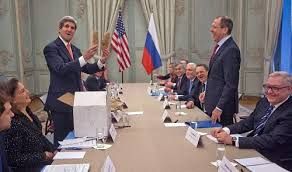 US Secretary of State John Kerry (L) holds Idaho potatoes as a gift for Russia's Foreign Minister Sergei Lavrov
