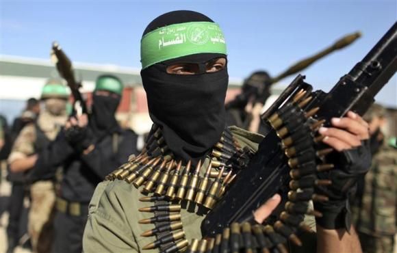 Palestinian members of the al-Qassam brigades, the armed wing of the Hamas movement, stand guard as they wait for the arrival of Hamas chief Khaled Meshaal in Rafah in the southern Gaza Strip in this December 7, 2012 file photograph.