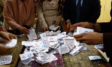 Egyptian election workers count ballots at the end of the second, final day of a key referendum on a new constitution, inside a polling station in Cairo, Egypt, Wednesday, Jan. 15, 2014. 