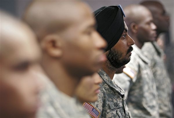 U.S. Army Spc. Simran Lamba, center, the first enlisted Soldier to be granted a religious accommodation for his Sikh articles of faith since 1984, stands in formation with fellow soldiers before taking the oath of citizenship, prior to his graduation from basic training at Fort Jackson, S.C