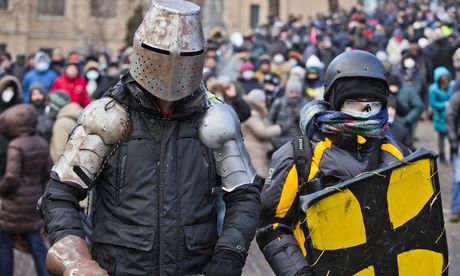 Ukrainian protesters take to the streets in homemade suits of armour. Photograph: Evgeny Feldman/AP
