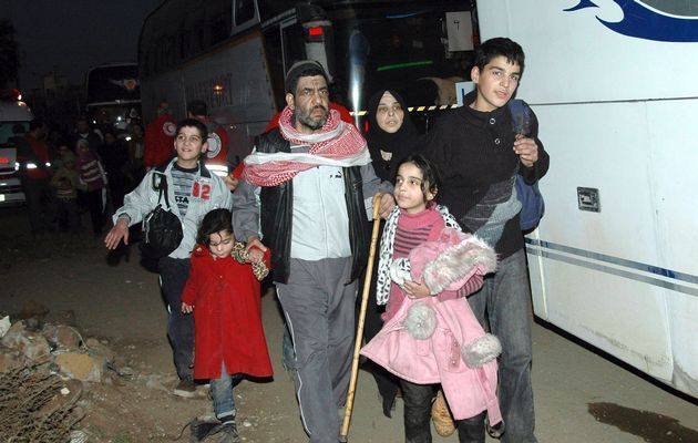 A family from a besieged area of Homs arrive to the area under government control February 9, 2014. n this handout released by Syria's national news agency SANA.  Image by: SANA / REUTERS