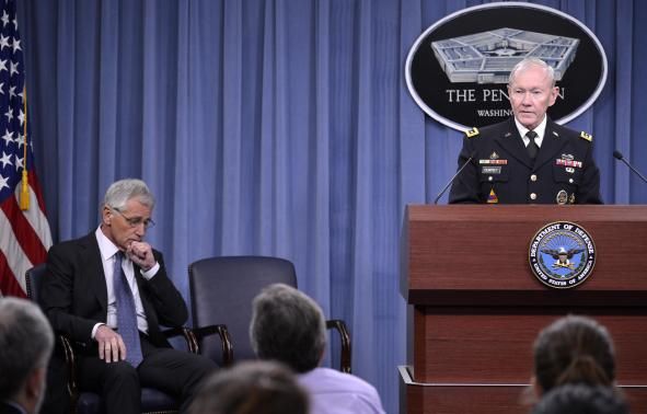 Chairman of the Joint Chiefs of Staff Martin Dempsey (R) makes remarks to the press as U.S. Secretary of Defense Chuck Hagel listens, at the Pentagon, Arlington, Virginia, February 24, 2014. 