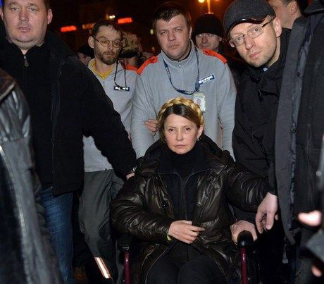 Head of the opposition Batkivshchyna Party Arseniy Yatsenyuk (R) holds the hand of newly freed Ukrainian opposition icon Yulia Tymoshenko as she arrives to speak at Independence Square on Feb. 22, moments after parliament voted to hold early presidential elections in May.