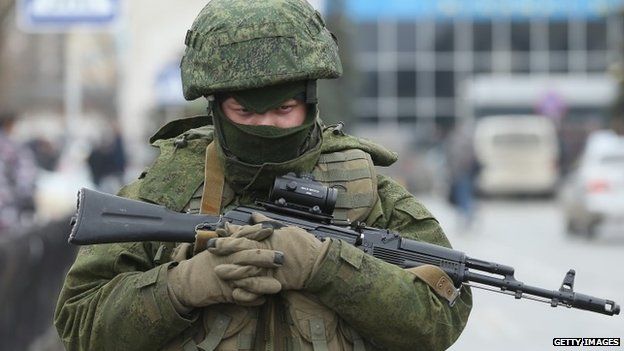 Armed man at Simferopol airport They have declined to say who they are, and are wearing no identifying insignia