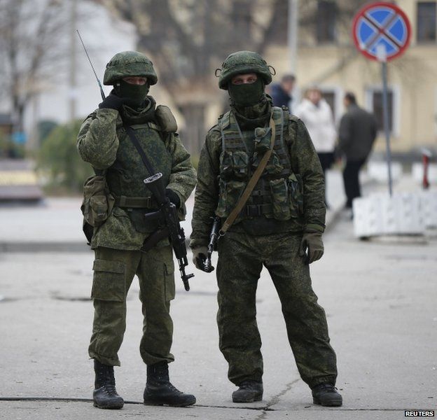 Unidentified soldiers are guarding key installations in Crimea