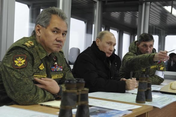 Russia's President Vladimir Putin (C), Defence Minister Sergei Shoigu (L) and head of the Russian army's main department of combat preparation Ivan Buvaltsev watch military exercises at the Kirillovsky firing ground in the Leningrad region, March 3, 2014. 