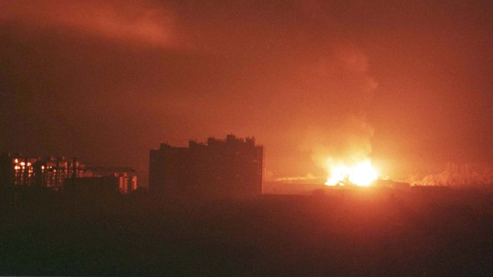 An explosion followed by a huge fire rages in the south-west part of Pristina in the early hours March 25, 1999 after NATO forces launched a missile attack against Yugoslavia (Reuters 