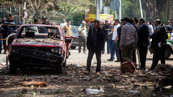 Egyptians inspect the damage after twin bombs struck police posts near Cairo University in the centre of Egypt's capital on April 2, 2014, which was followed by a third blast as police and journalists gathered at the scene. (AFP Photo