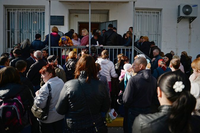 The line outside the government office in Simferopol, the capital of Crimea, where new Russian passports were being processed. Credit James Hill for The New York Times