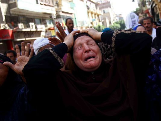 An Egyptian woman mourns after a judge in Egypt sentenced to death 683 alleged supporters of the country's ousted Islamist president in the southern city of Minya, Monday.
