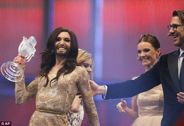 Ecstatic: The singer celebrates as she is awarded the winner's trophy for Eurovision 2014