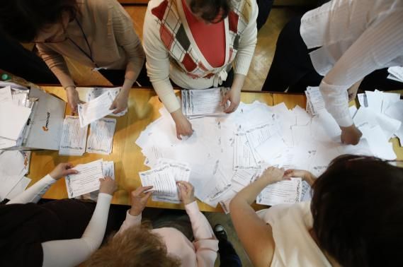 Members of a local election commission count votes of the referendum on the status of Donetsk region in Donetsk May 11, 2014. 