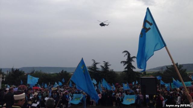 Helicopters circle overhead at a rally by Crimean Tatars in Bakhchyseray on May 18.