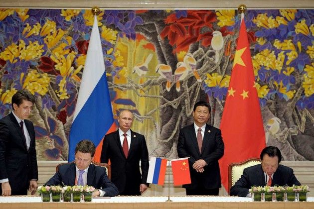 Xi (standing, right center) and Putin (left center) at the signing ceremony in Shanghai with Gazprom's Miller (seated, left) and CNPC Chairman Zhou Jiping (seated, right)