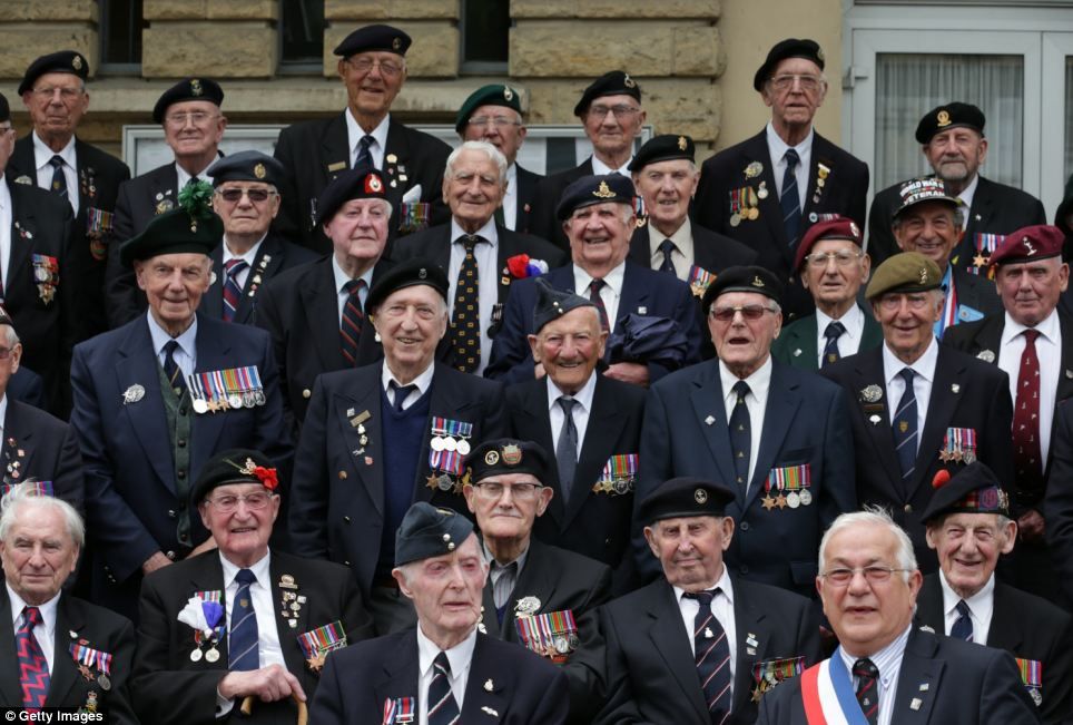 A group of veterans gather for a photograph with the local mayor at a civic function in the village of Thury-Harcourt near Caen during their action packed day  Read more: http://www.dailymail.co.uk/news/article-2648320/D-Day-veterans-embark-ferry-journey-ahead-70th-anniversary-celebrations-invasion-Europe.html#ixzz33m1p9a00  Follow us: @MailOnline on Twitter | DailyMail on Facebook