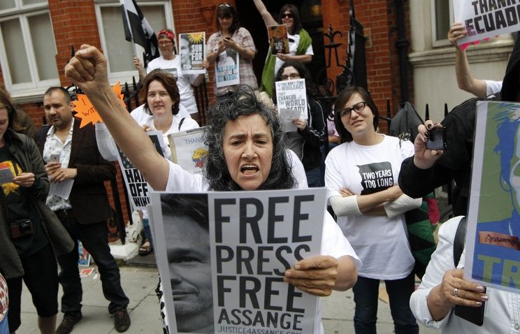 Supporters of WikiLeaks founder Julian Assange hold a vigil outside the Ecuadorian Embassy in London on June 19