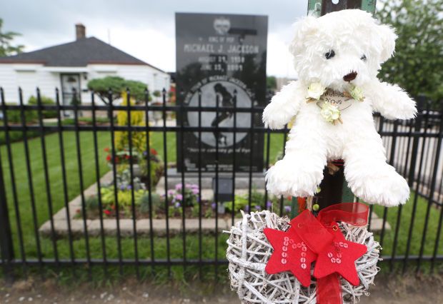 A stuffed bear and a heart decoration adorn a sign posted outside Michael Jackson's childhood home at 2300 Jackson St. in Gary on Tuesday, the day before the fifth anniversary of his death.