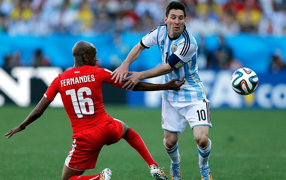 Switzerland's Gelson Fernandes, left, tries to stop Argentina's Lionel Messi during the World Cup round of 16 soccer match between Argentina and Switzerland at the Itaquerao Stadium in Sao Paulo, Brazil.