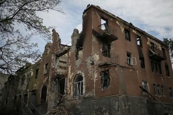 Buildings damaged by a recent shelling are seen in the eastern Ukrainian village of Semenovka July 9, 2014.