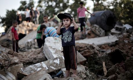 A Palestinian boy plays in the rubble of a house destroyed in an Israeli air strike on Beit Hanoun, Gaza. Photograph