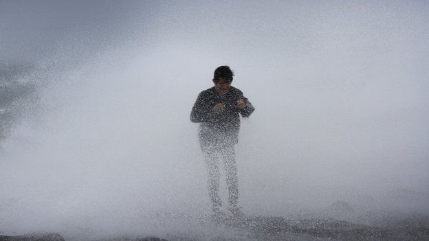 A resident in Legazpi City is hit by strong waves