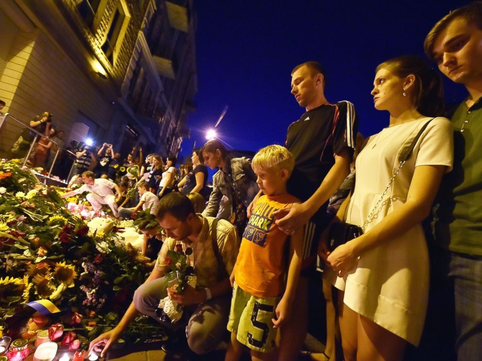  People lay flowers and light candles in front of the Embassy of the Netherlands in Kiev on July 17, 2014, to commemorate passengers of Malaysian Airlines flight MH17 from Amsterdam to Kuala Lumpur which crashed in eastern Ukraine.