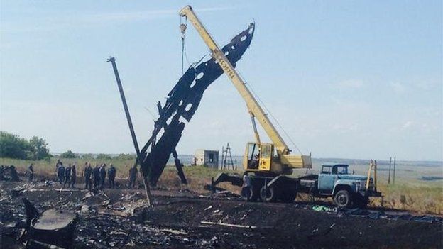 A crane at the crash site lifting large pieces of debris, 20 July 2014  A crane could be seen at the crash site lifting large pieces of wreckage
