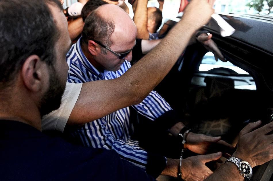 Members of the media gather around former head of the anti-terror department of the Istanbul police, Ali Fuat Yilmazer
