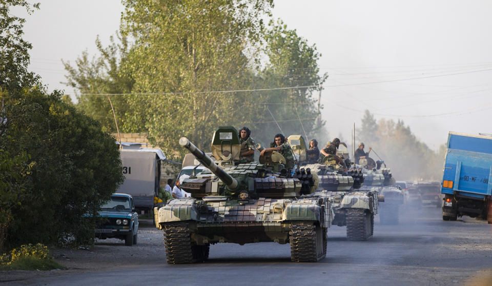 In this Saturday, Aug. 2, 2014, photo a convoy of Azerbaijan's Army tanks moves in the direction of Agdam, Azerbaijan. Recent days have seen a sharp escalation in fighting between Azerbaijan and Armenia around a tense line of control around Nagorno-Karabakh. (AP)