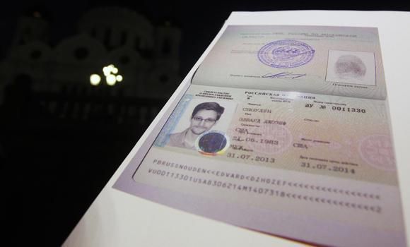 File photo of fugitive former US spy agency contractor Edward Snowden's new refugee documents granted by Russia displayed during a news conference in Moscow on August 1, 2013. (Reuters)