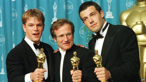 Williams with his Oscar, flanked by co-stars Matt Damon and Ben Affleck