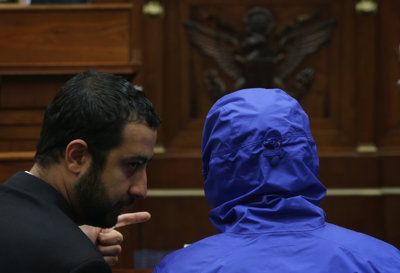 yrian Army defector Caesar, (in a blue hooded jacket) who has smuggled out of Syria more than 50,000 photographs …