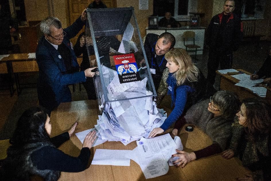 Electoral workers empty a ballot box to start counting ballots for the leadership vote 