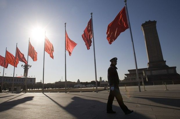 A police officer patrols Tiananmen Square.